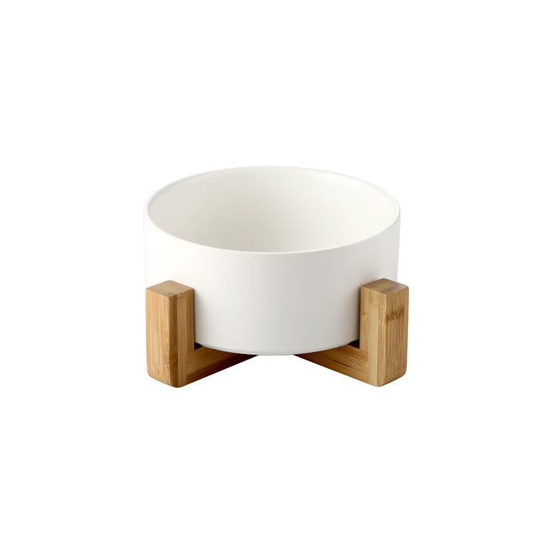 White ceramic pet bowl with elevated natural wood stand