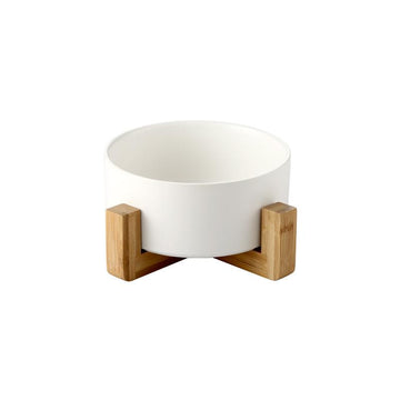 White ceramic pet bowl with elevated natural wood stand