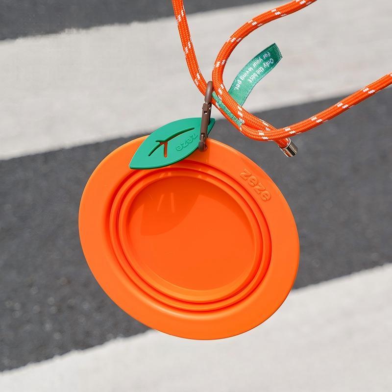 Red fruit-shaped collapsible silicone pet travel bowl with carabiner clip