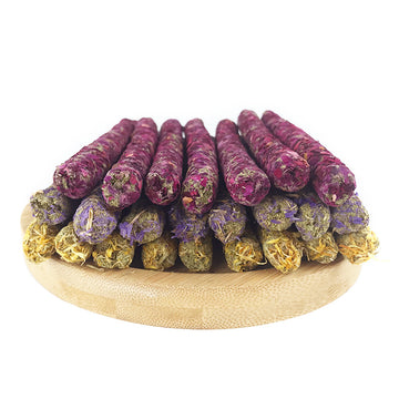 Mixed flower petal forage molar sticks on white plate for rabbits and small pets