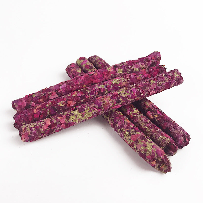 Mixed flower petal forage molar sticks on white plate for rabbits and small pets
