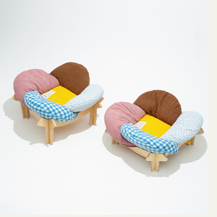 Brown birch wood cat bed with gingham cushion and natural wood frame